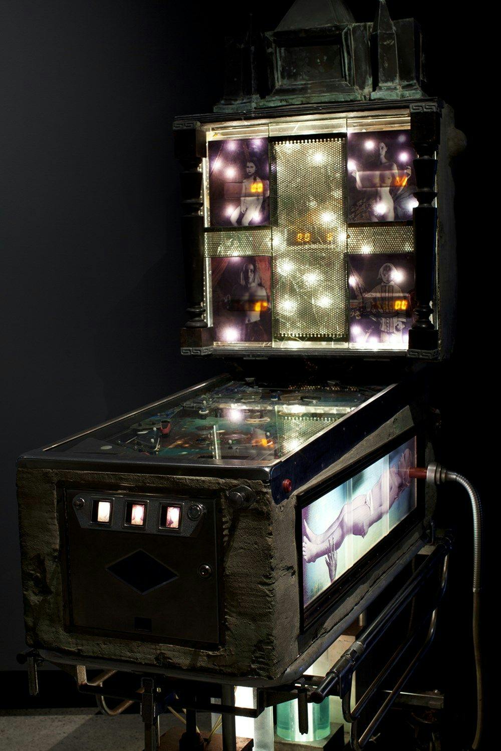 A dimly lit pinball machine.
