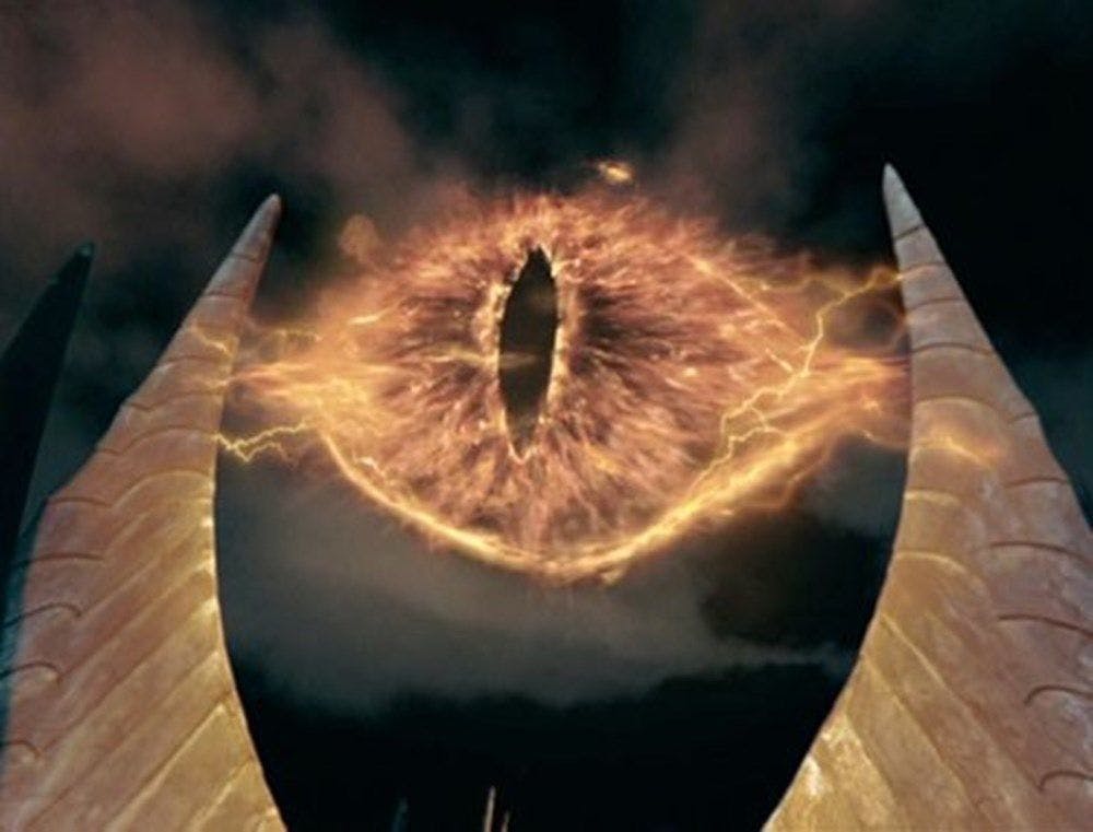 Gigantic lidless eye created by fields of energy on dark background.