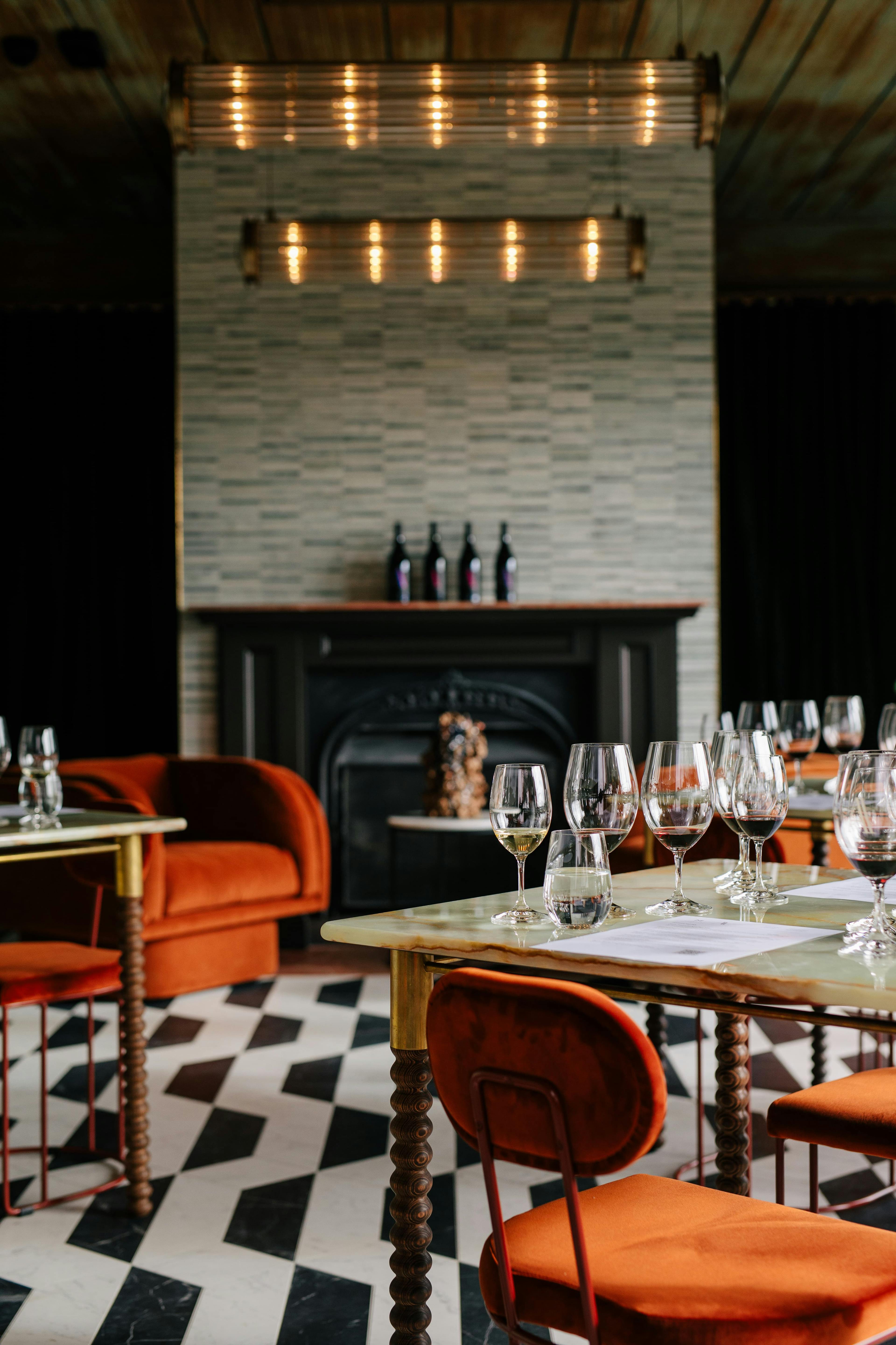 Domaine A cellar door, orange chairs, ornate tables with wine tastings prepared