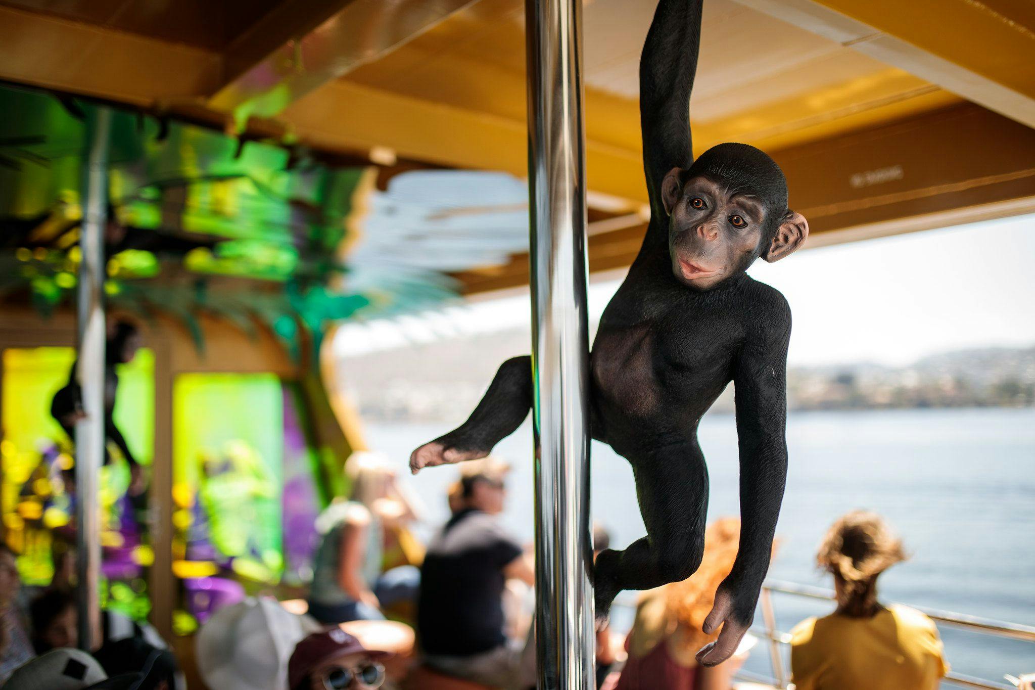 A plastic Chimpanzee hangs from a pole onboard the ferry.