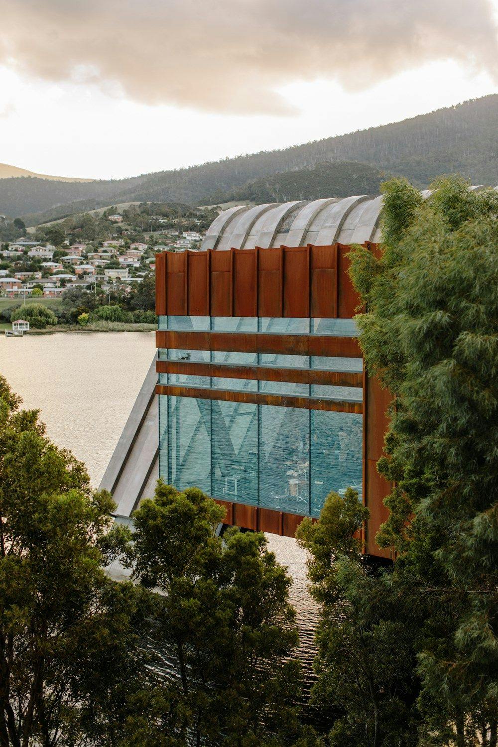 Side profile of Pharos with glass, concrete and corten steel.