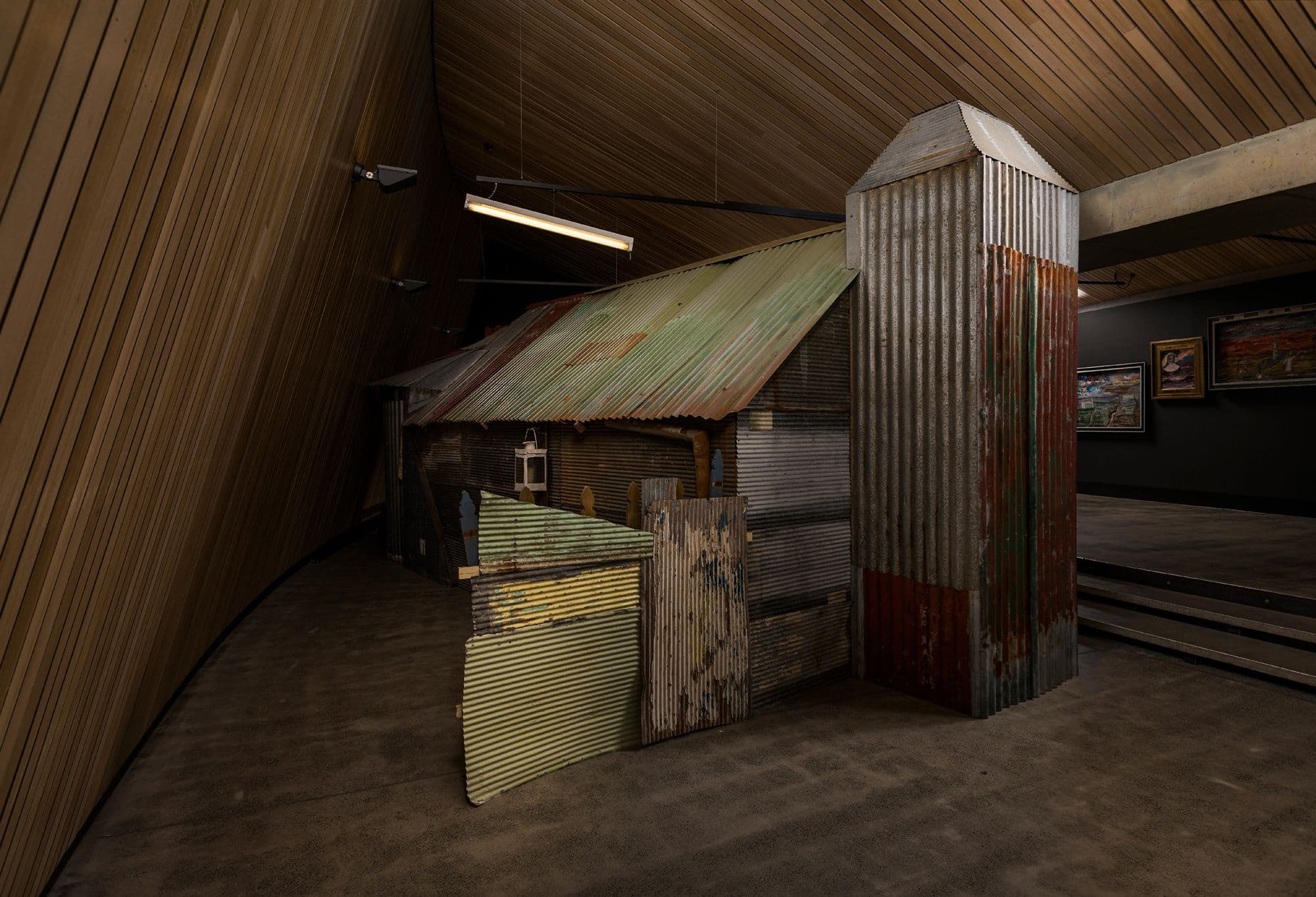 A small cabin composed of weathered roofing iron