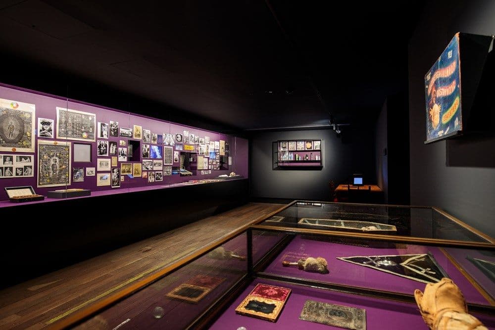 An exhibition space containing cabinets with a range of objects