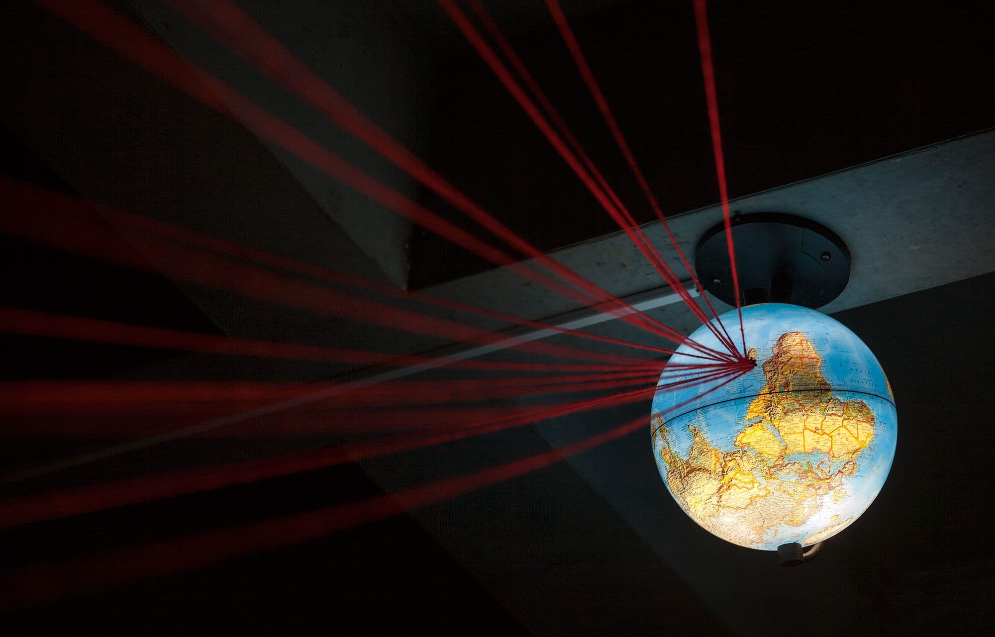 A globe with red strings attached