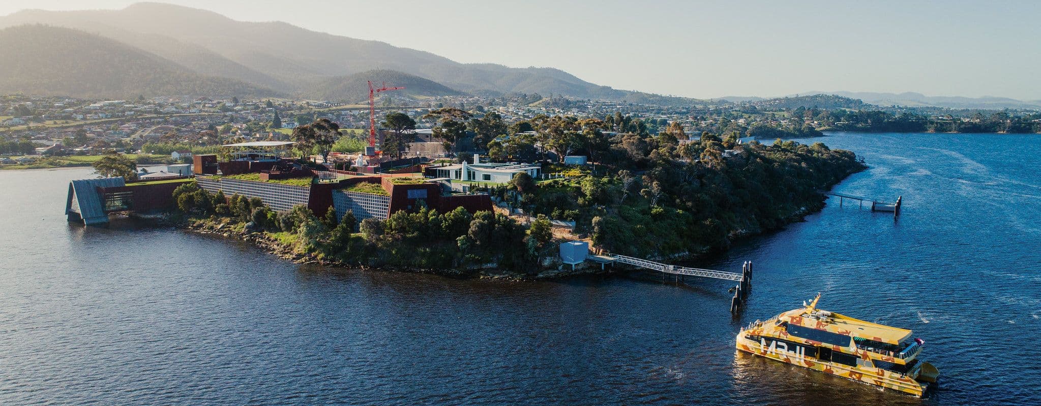Aerial image of the ferry inbound to the Mona site